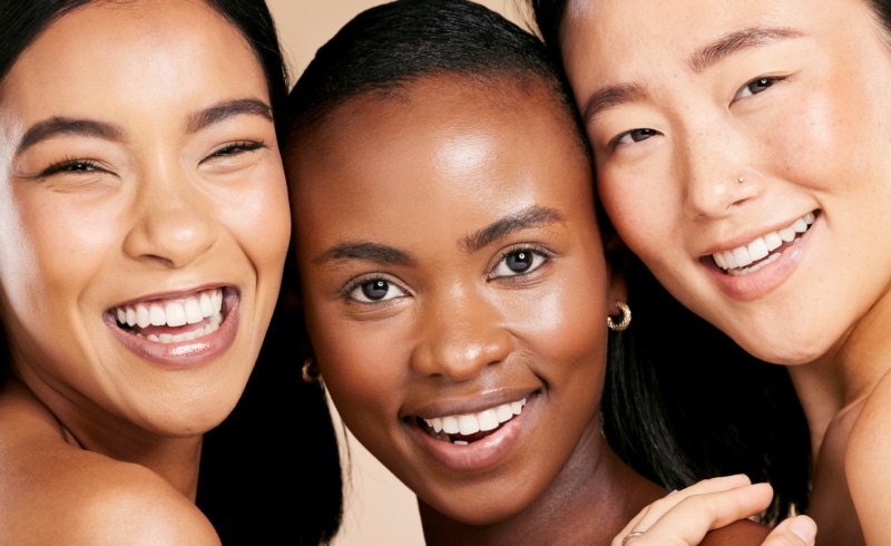 Group portrait of 3 happy women smiling