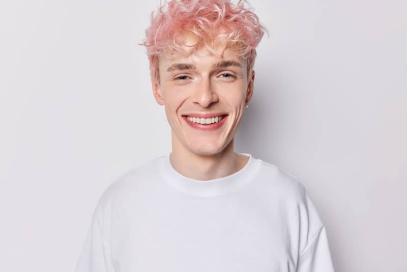 Portrait of handsome pink haired man smiling
