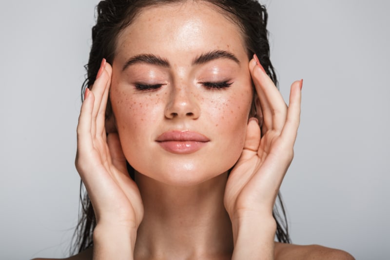 Portrait of young brunette woman with eyes closed