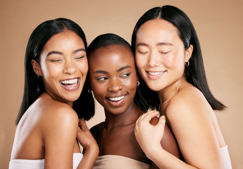 Skincare, beauty and diversity, happy women with smile and eyes closed on studio background