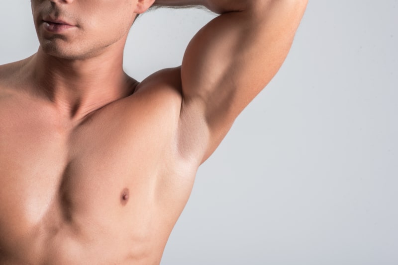 Cropped photo of muscular man with hairless body