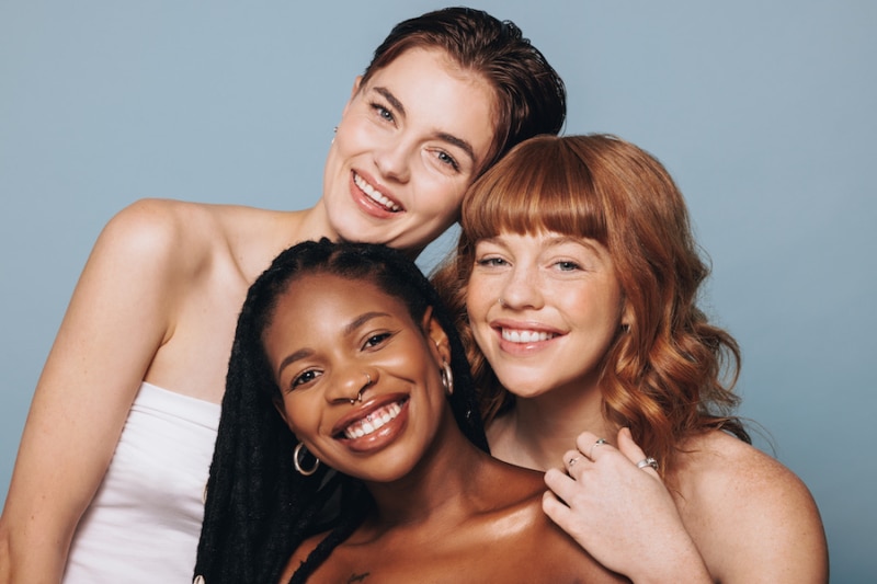 Portrait of women with different skin tones smiling